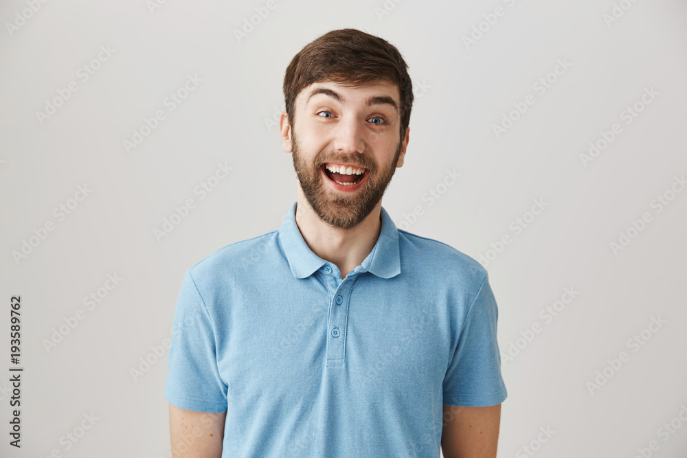 So happy to see you. Studio shot of enthusiastic funny male employee smiling cheerfully and lifting eyebrows in surprise, standing over gray background. Mature man unexpectedly met his school mate So happy to see you. Studio shot of enthusiastic funny male employee smiling cheerfully and lifting eyebrows in surprise, standing over gray background. Mature man unexpectedly met his school mate