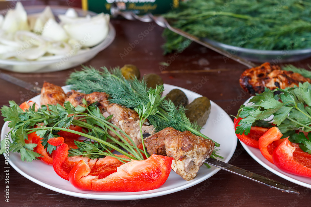 In a white plate are fresh vegetables with meat cooked on the grill. In a white plate are fresh vegetables with meat cooked on the grill.