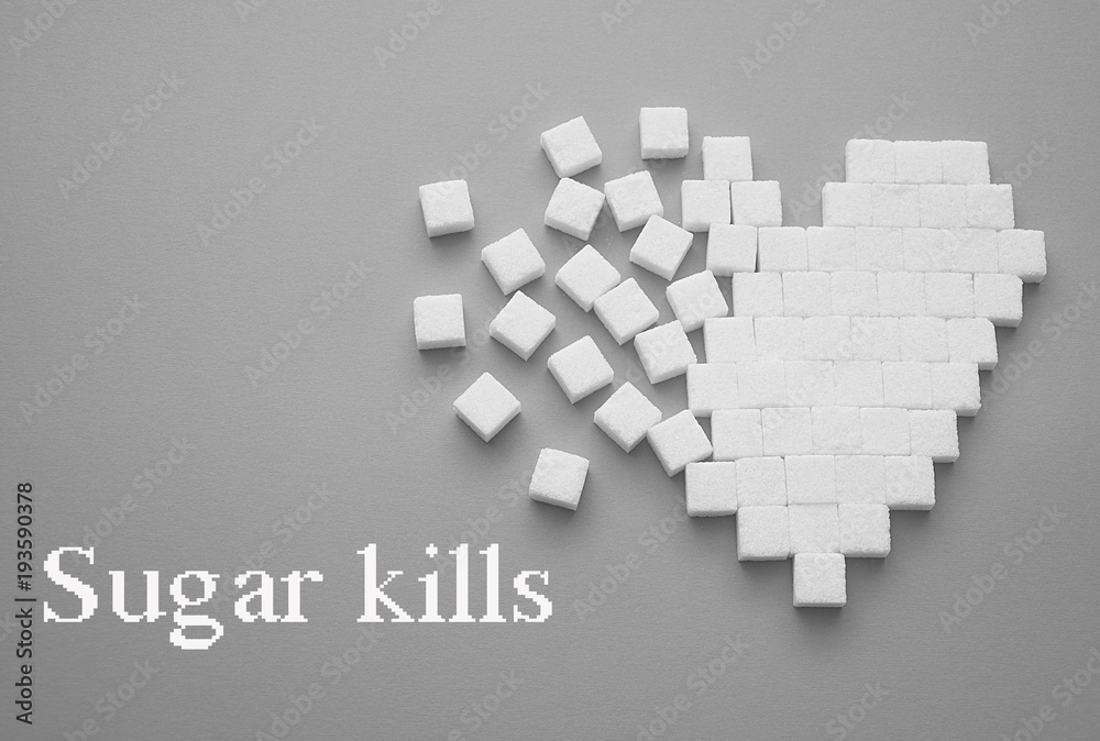 Broken heart made of sugar cubes. Rupture of relations. Sugar kills. Gray background. Empty space for copying text. Broken heart made of sugar cubes. Rupture of relations. Sugar kills. Gray background. Empty space for copying text.