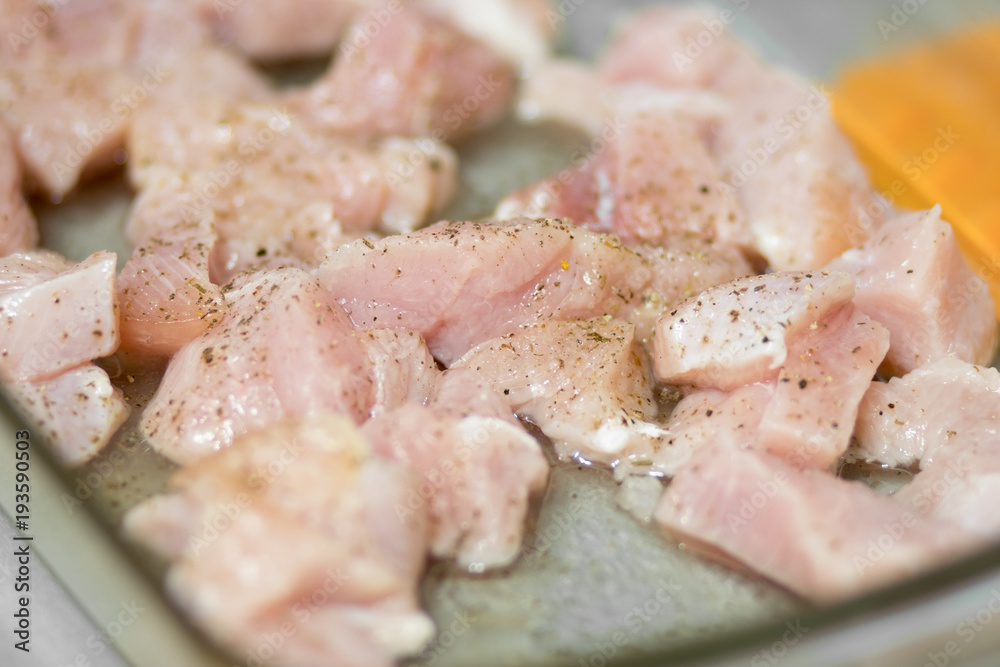 Sliced poultry meat, lying on a baking sheet and ready to bake Sliced poultry meat, lying on a baking sheet and ready to bake