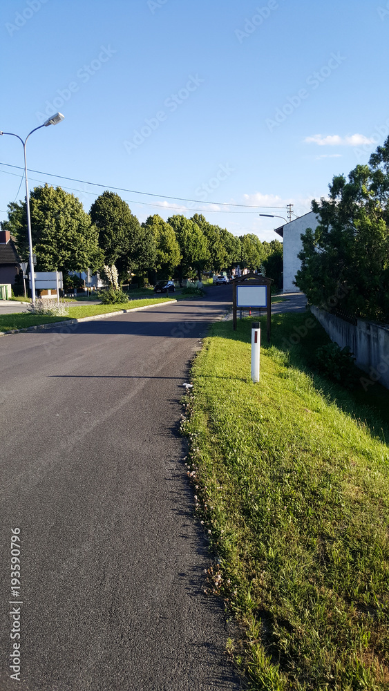 A road in an Austrian village with an empty sign A road in an Austrian village with an empty sign