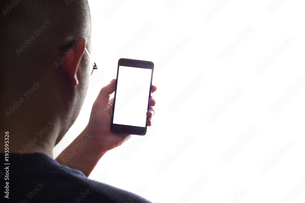 Man with glasses looking at mobile phone in hand with white screen and background