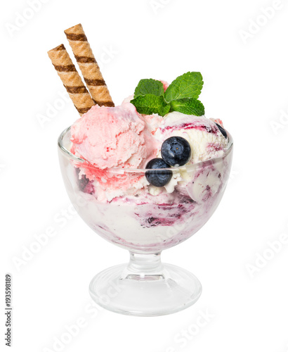 Ice cream with fresh blueberries, mint and wafer sticks in glass vase