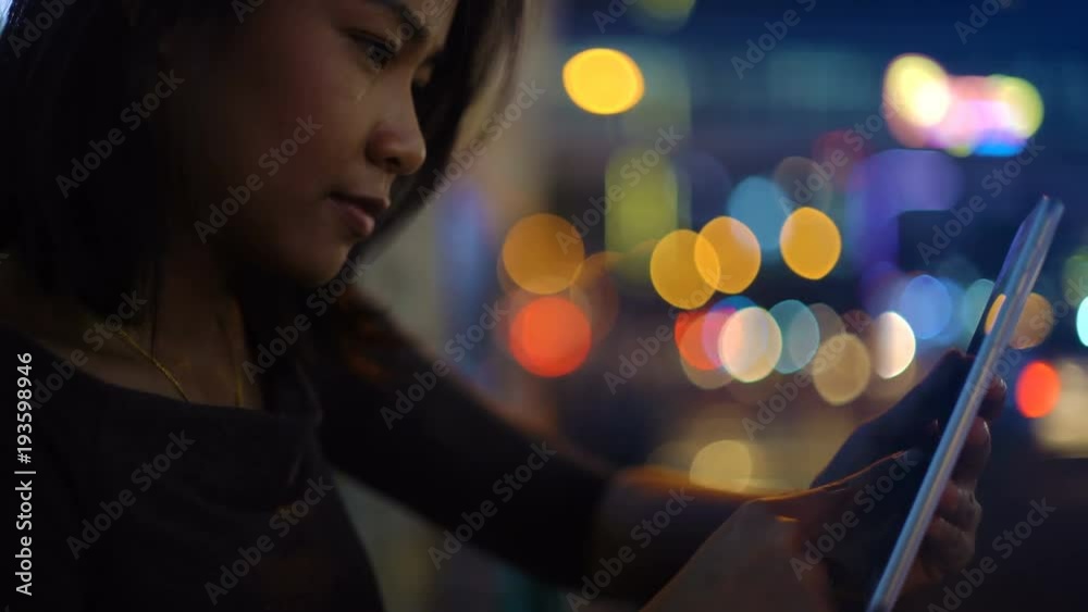Unrecognizable Asian Girl talking on smartphone in night city 4k UHD (3840x2160)
