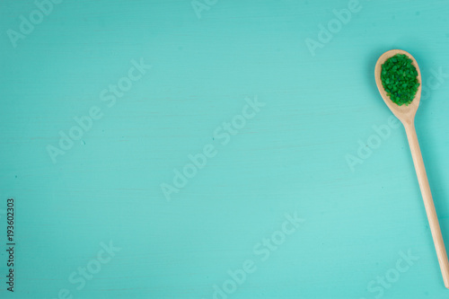 Green bath salt on blu background