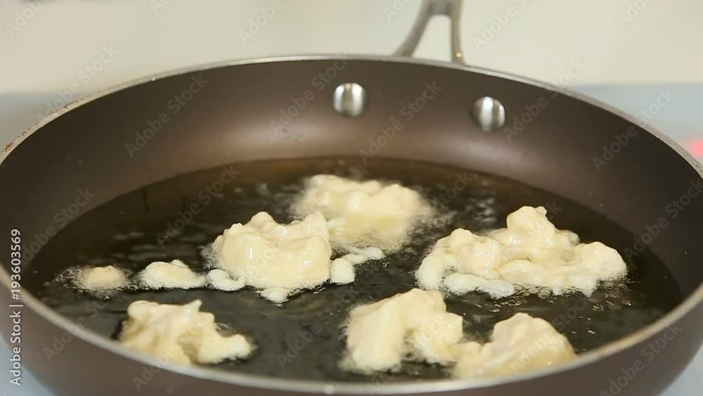 Deep frying breaded fish fillet slices on a pan Deep frying breaded fish fillet slices on a pan