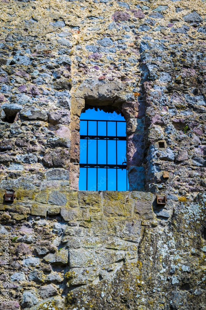 Old stone castle window, clear sky in background. Sky view through old stone castle window, Visegrad, Hungary. Old stone castle window, clear sky in background. Sky view through old stone castle window, Visegrad, Hungary.
