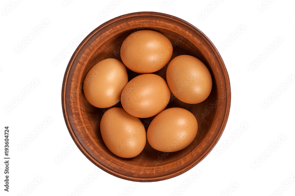 Brown chicken organic eggs in clay bowl. Isolated on white background. Nutritious and protein reserve Brown chicken organic eggs in clay bowl. Isolated on white background. Nutritious and protein reserve
