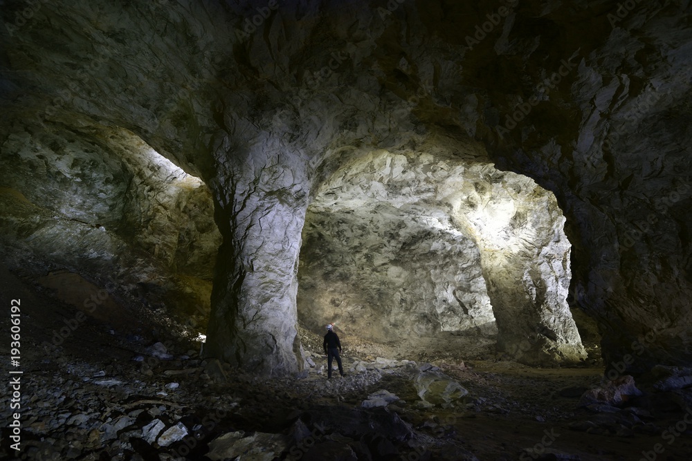 One Spelunker explore a beautiful cave with torch