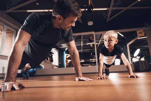 Father and son in the gym. Father and son spend time together and lead a healthy lifestyle.