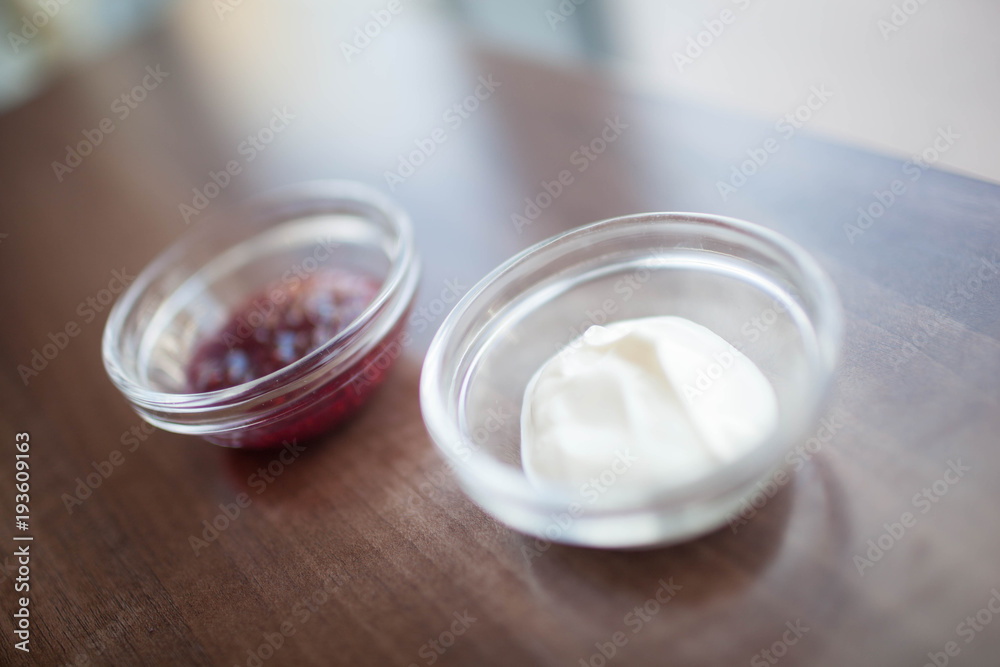 bowl of sour cream on white wooden table