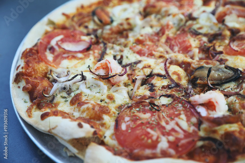 Seafood pizza , with mussel squid shrimp and tomato , italian food