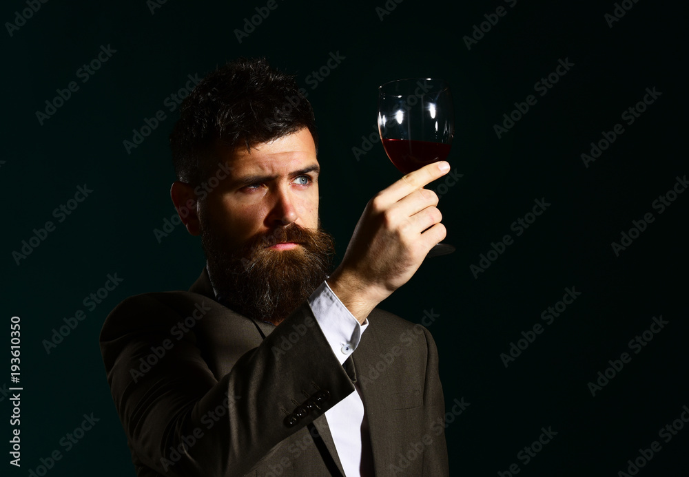 Connoisseur with serious face tasting expensive cabernet wine Connoisseur with serious face tasting expensive cabernet wine