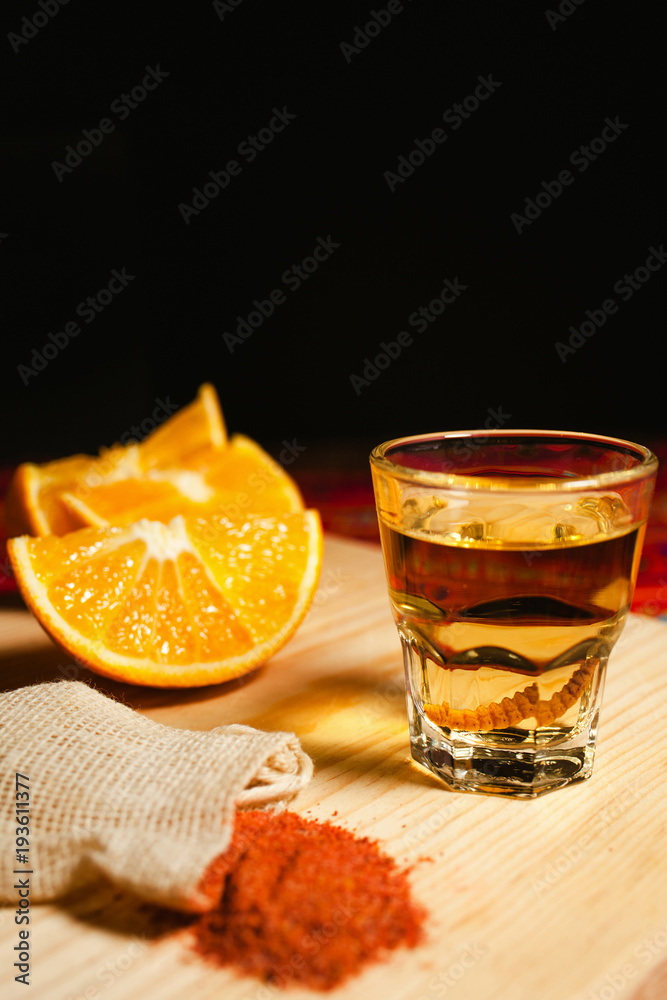 Mezcal shot mexican drink with orange slices and worm salt in oaxaca mexico Mezcal shot mexican drink with orange slices and worm salt in oaxaca mexico