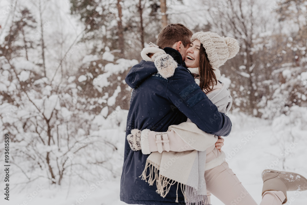 Happy Young Couple in Winter Park having fun.Family Outdoors. love Happy Young Couple in Winter Park having fun.Family Outdoors. love
