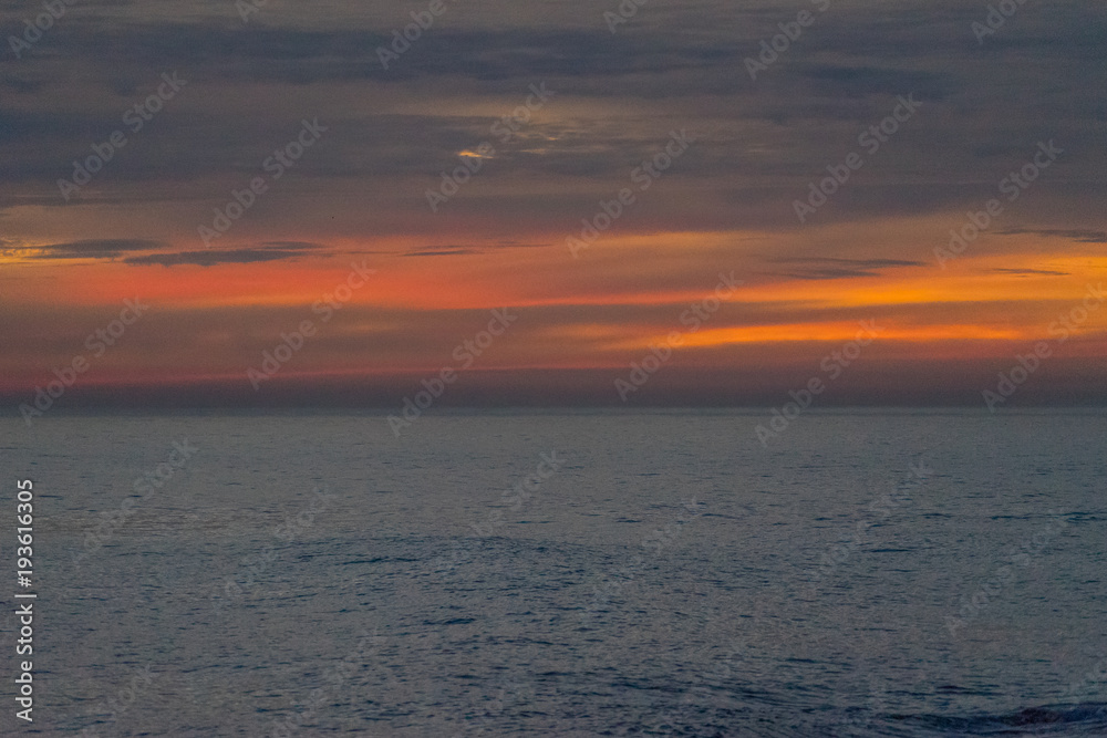 Obraz premium landscape from a height overlooking the sea and a bright sunset.