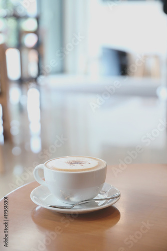 cappuccino or Latte art coffee made from milk on the wood table in coffee shop