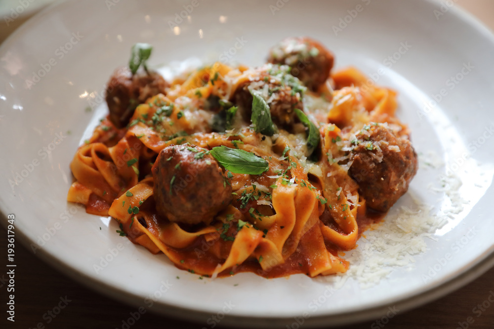 Spaghetti pasta with beef meatballs and tomato sauce on wood background . italian food Spaghetti pasta with beef meatballs and tomato sauce on wood background . italian food