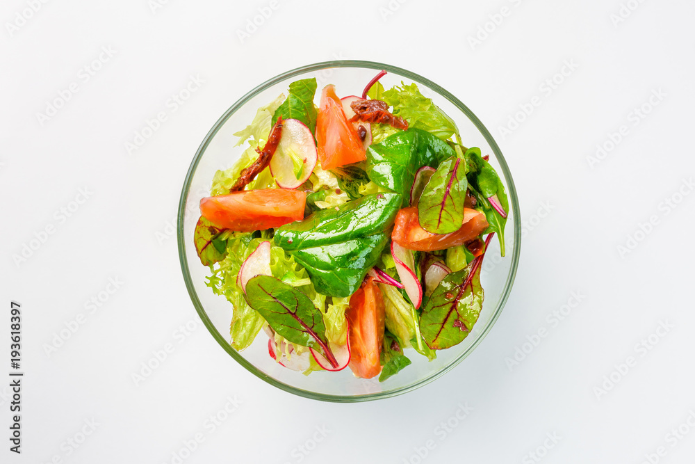 Lenten salad with lettuce, radishes and tomatoes on a white background Lenten salad with lettuce, radishes and tomatoes on a white background