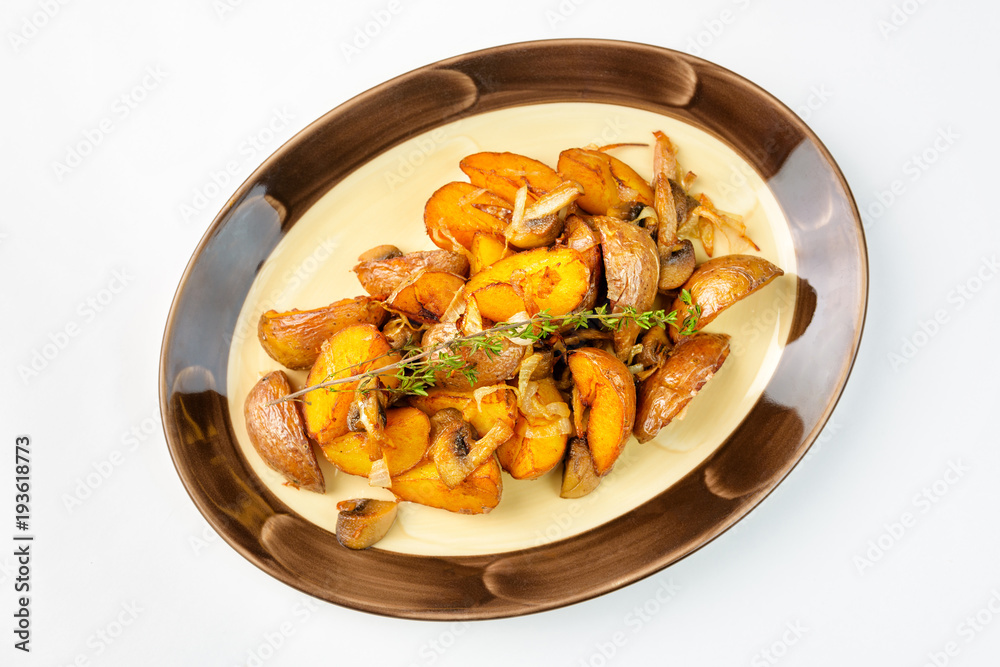 Fried potatoes with mushrooms on a white background Fried potatoes with mushrooms on a white background