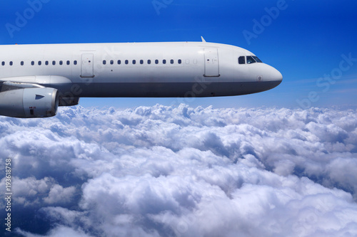 Safe flight of a passenger plane over the clouds  blue sky