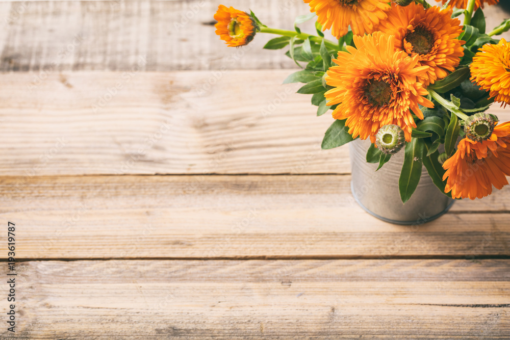 Calendula on wooden table, copy space, view from above - obrazy, fototapety, plakaty 