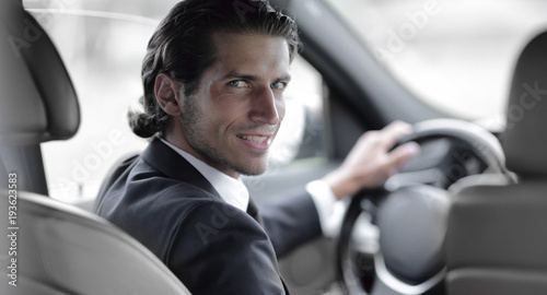 man sitting behind the wheel of a car © ASDF