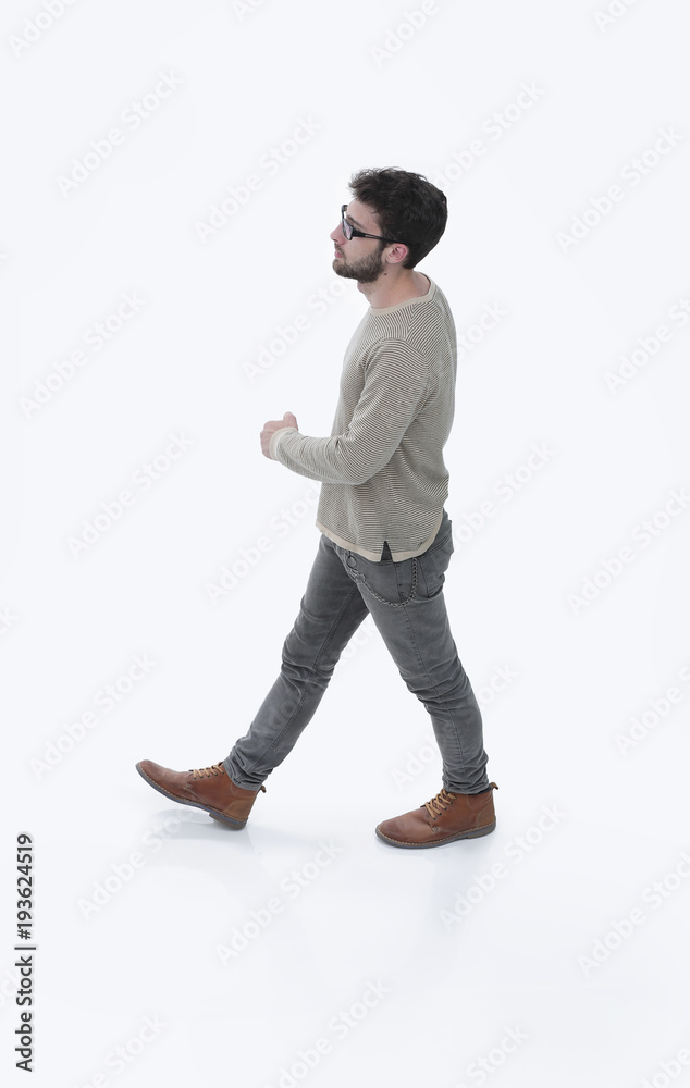 side view. modern young man confidently goes forward. side view. modern young man confidently goes forward.