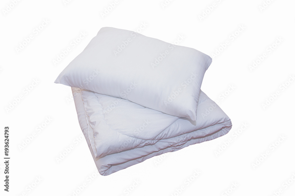 Roll of soft white blankets and white pillows isolated on white background Roll of soft white blankets and white pillows isolated on white background