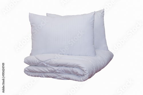 Roll of soft white blankets and white pillows isolated on white background