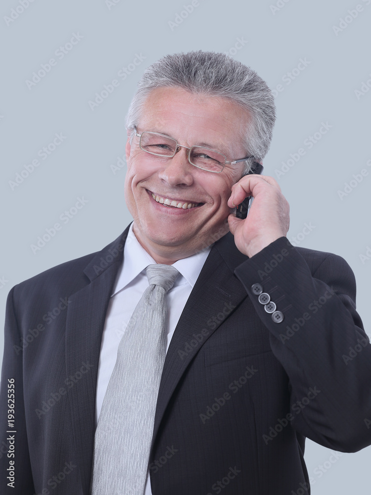 Gray-haired business man smiling isolated on gray background. Gray-haired business man smiling isolated on gray background.