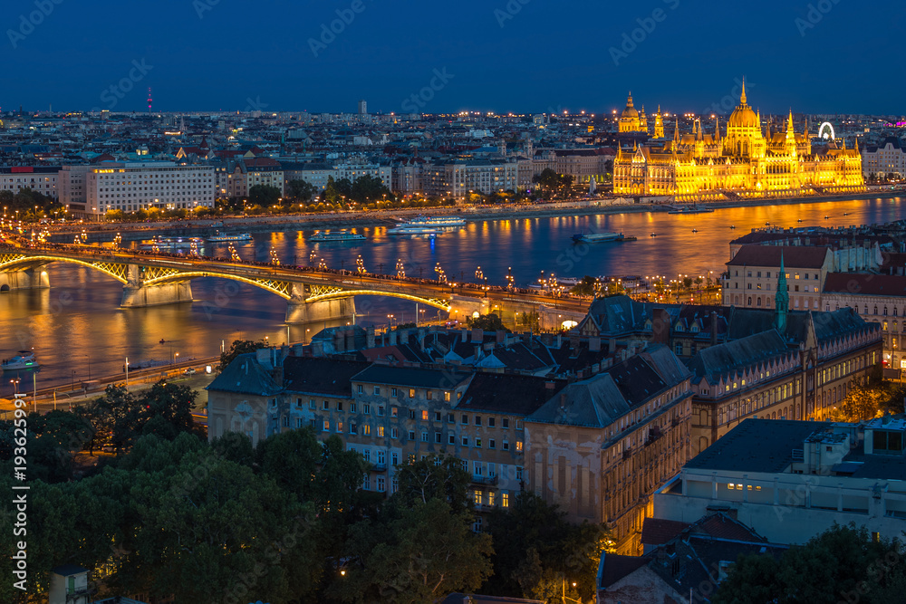 Budapest, Hungary - Panoramic skyline view of Budapest with the illuminated Parliament of Hungary, Margaret Bridge and Margaret Island at blue hour