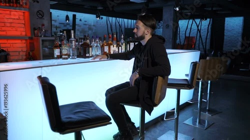 Man is sitting in the bar