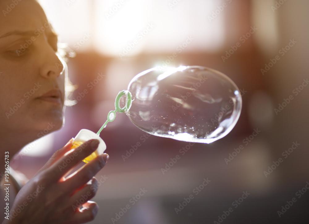 Young woman blowing bubble Young woman blowing bubble