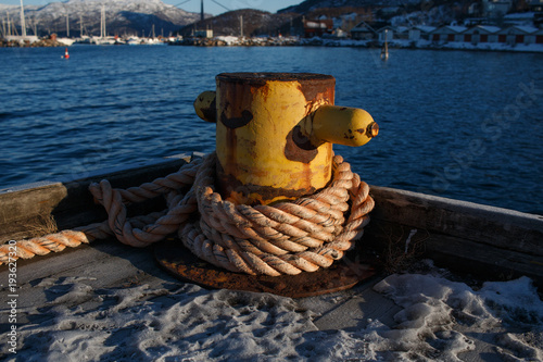 Rusty bitt at harbor in Narvik, Norway, bollar