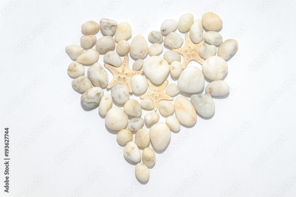 Heart on a white background lined with small white decorative stones, concept romantic, love