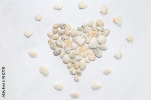 Heart on a white background lined with small white decorative stones, concept romantic, love