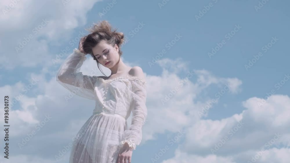 Nice girl. Blue sky. Dreaming. Girl posing. lovely girl enjoys beautiful spring day. Nice girl. Blue sky. Dreaming. Girl posing. lovely girl enjoys beautiful spring day.