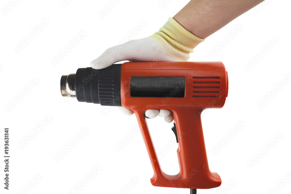 Orange heat gun in the hand in glowe on the white background isolated