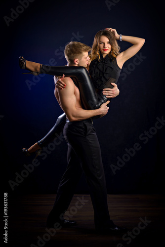 playful young couple posing in studio