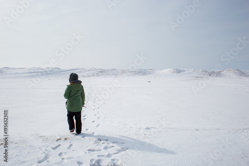 Young woman adventuring in a frozen landscape