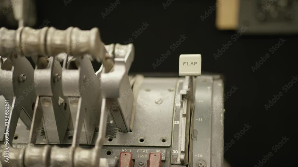 Closeup of hand pulling lever in a cockpit