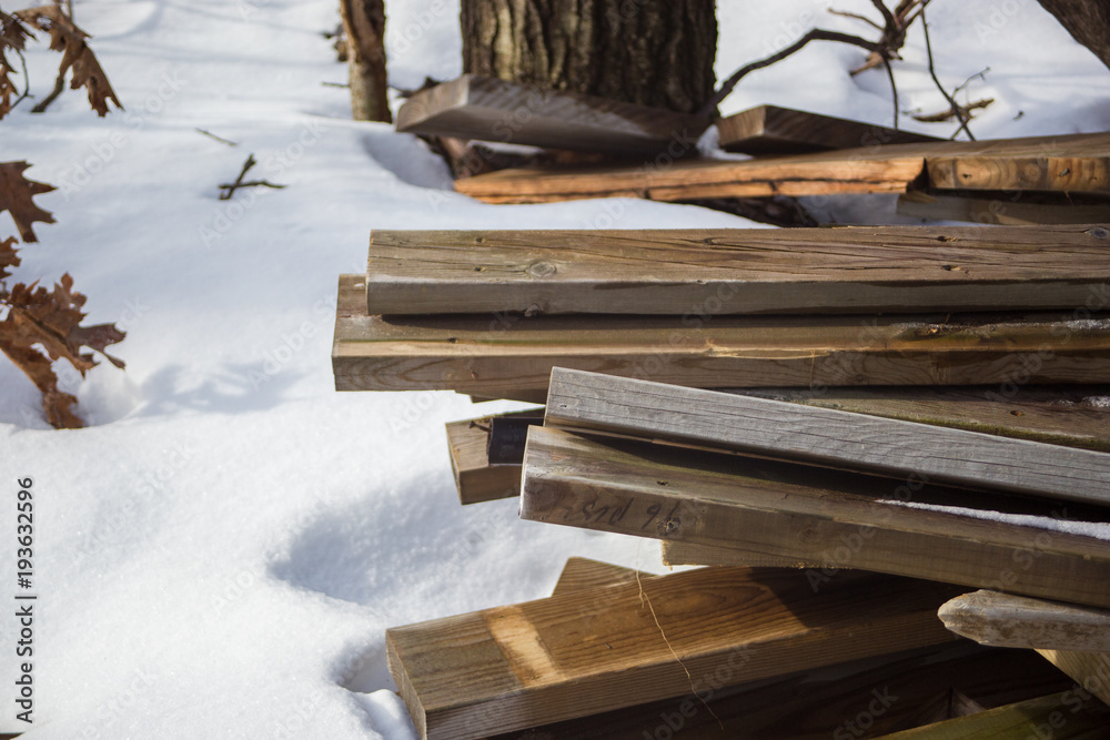 Lumber in frozen woods surrounded by snow Lumber in frozen woods surrounded by snow