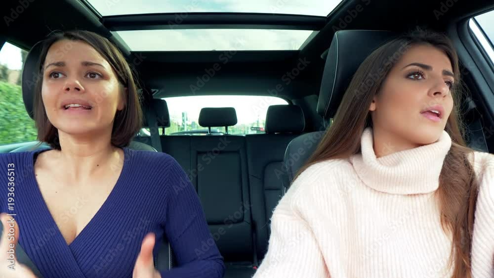 Two women discussing angry in car unhappy Two women discussing angry in car unhappy