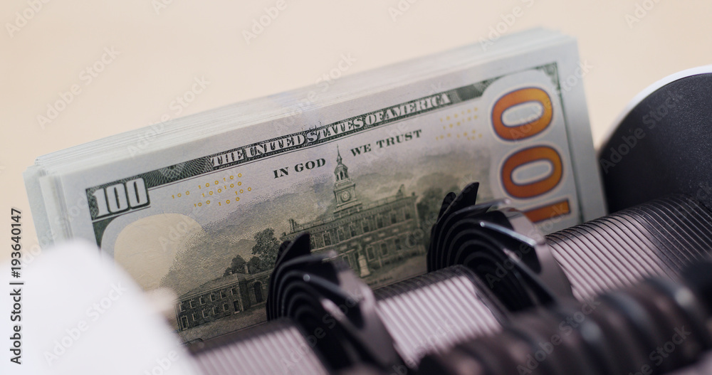 USD banknote on money counting machine USD banknote on money counting machine