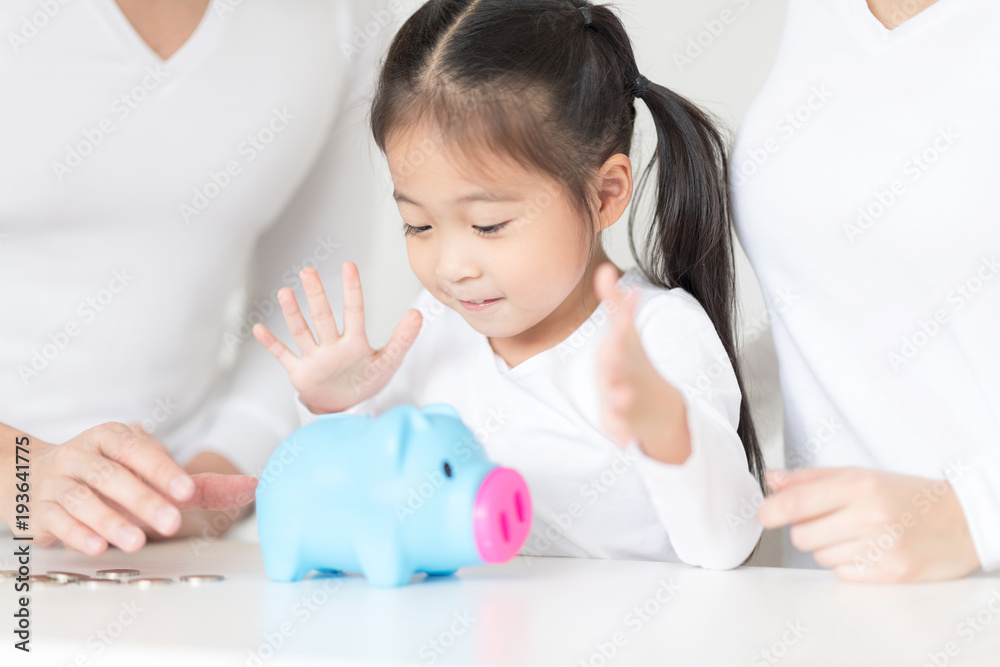 Parents are teaching daughter on saving money and financial planning. Parents are teaching daughter on saving money and financial planning.