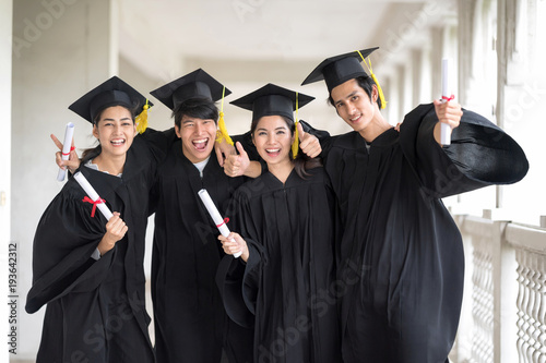 Graduation day, Images of Happily graduates are celebrating graduation, a certificate in hand, Happiness feeling, Commencement day, Congratulation. Education Concept.