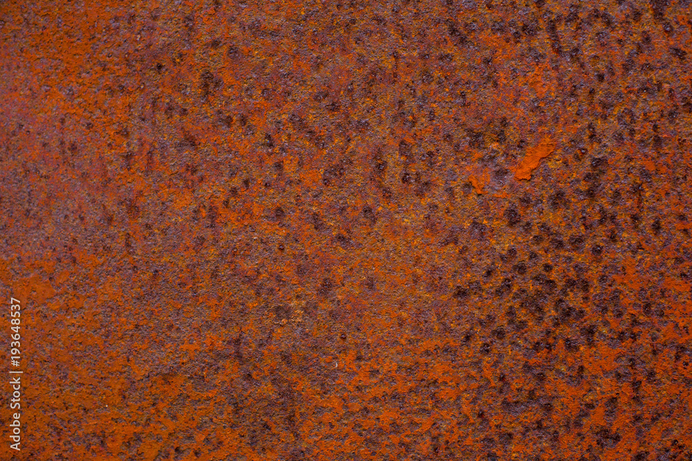 Rusty yellow-red textured metal surface. The texture of the metal sheet is prone to oxidation and corrosion. Grunge background Rusty yellow-red textured metal surface. The texture of the metal sheet is prone to oxidation and corrosion. Grunge background
