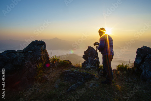 Men who are taking nature pictures Sunset time, silhouette