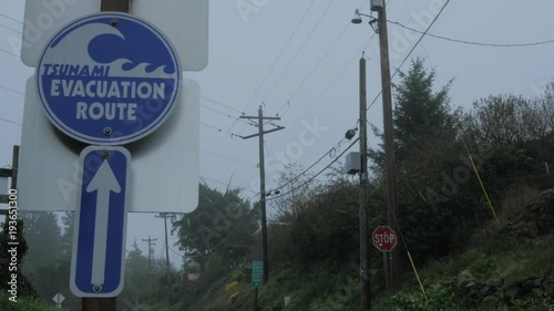 Windy stormy day near the coast of Oregon pan of a warning sign.